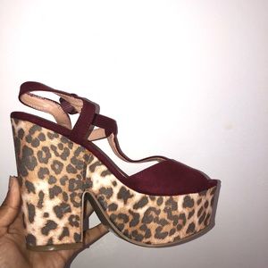 Burgundy and cheetah print heels with toes out.